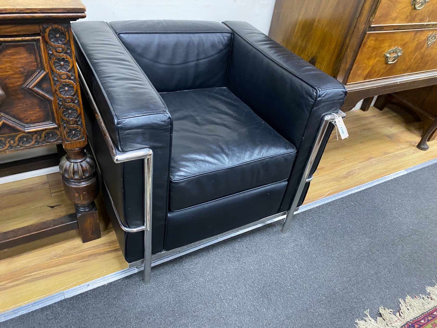 A pair of Corbusier style Cassina type black leather and chrome lounge chairs, width 74cm, depth 66cm, height 66cm